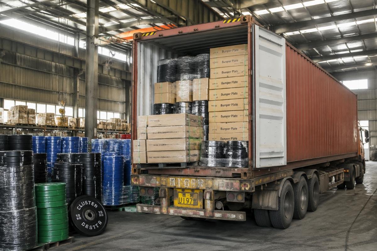 bulk fitness equipment shipping from China A full 40HQ container loaded with fitness equipment including bumper plates at a Chinese factory warehouse