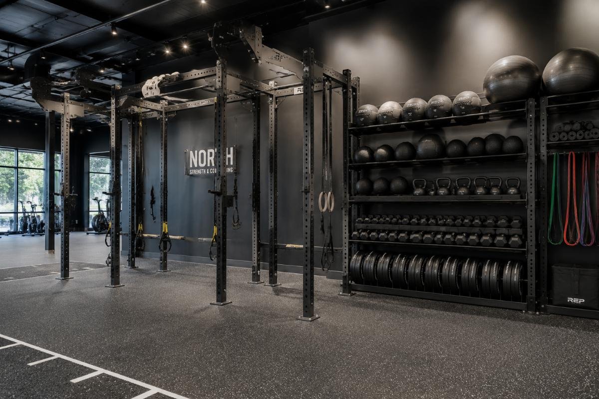 Functional training zone with modular rig and matching storage rack installed in a boutique gym